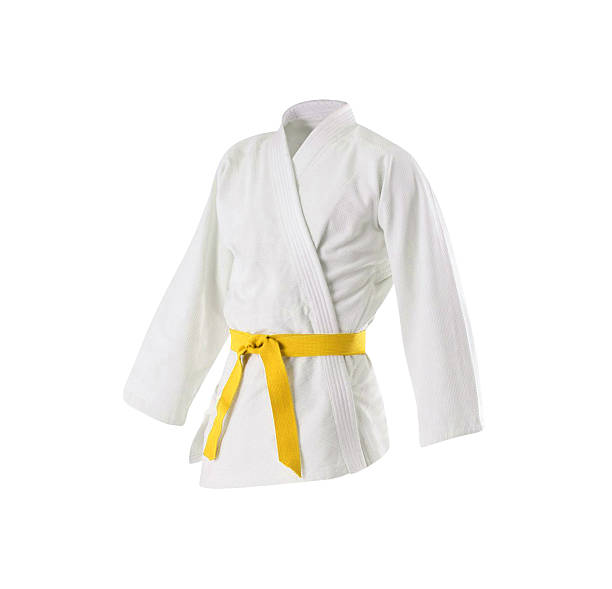 istock Judogi with yellow belt 596088032