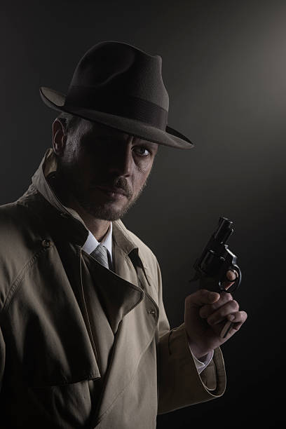 istock Film noir: detective in the dark with a gun 596090124