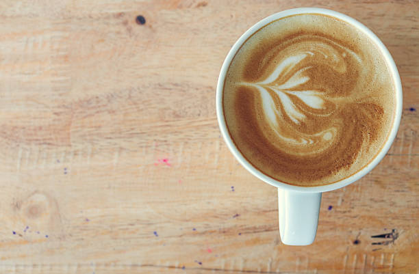 istock Coffee in white cup on wood table in coffee shop. 596092692
