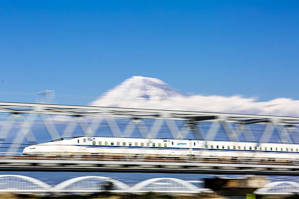 high speed train with motion blur Shizuoka, Japan - December 1, 2015: Shinkansen bullet train with Mt. Fuji landscape in Shizuoka ,Japan on DEC 1 ,2015. Shinkansen is world's busiest high-speed railway operated by four Japan Railways companies. bullet train mount fuji stock pictures, royalty-free photos & images