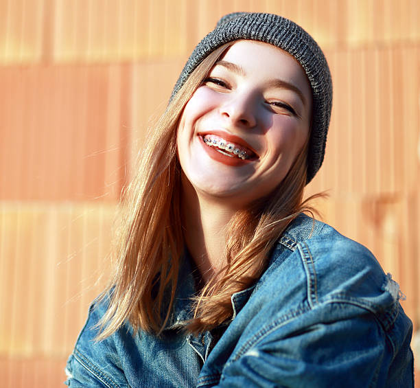 braces on her teeth beautiful blond teen girl with braces on her teeth smiling headwear stock pictures, royalty-free photos & images