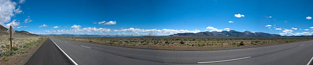 istock Panoramic view of a long straight road in California 596095974