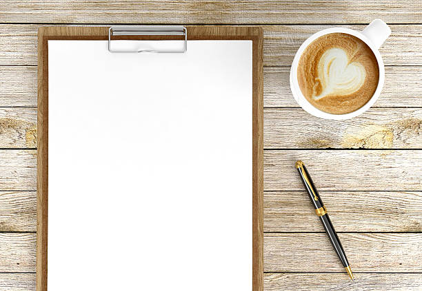 istock Cappuccino coffee cup with blank papers on clipboard and pen 596097278