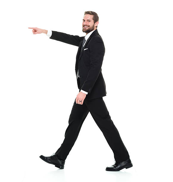 istock Smiling businessman pointing away 596097744