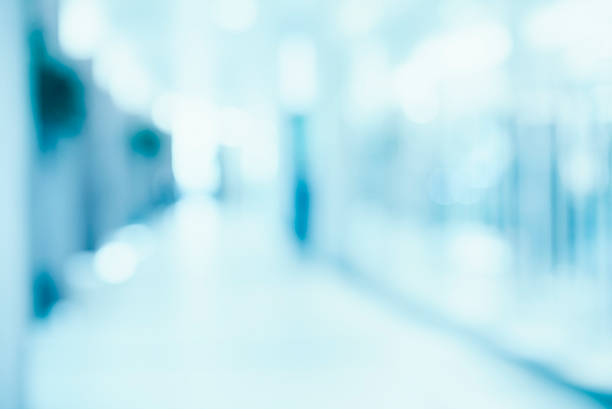 istock medical blurred background, empty hospital corridor in neon blue 596098068