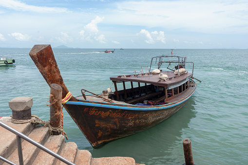 Krabi, Thailand - August 6, 2016: Old wooden boat anchored at Ao Nammao pier in Krabi, Thailand.