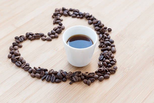 istock Coffee beans and black cup of coffee inside a heart 596339996