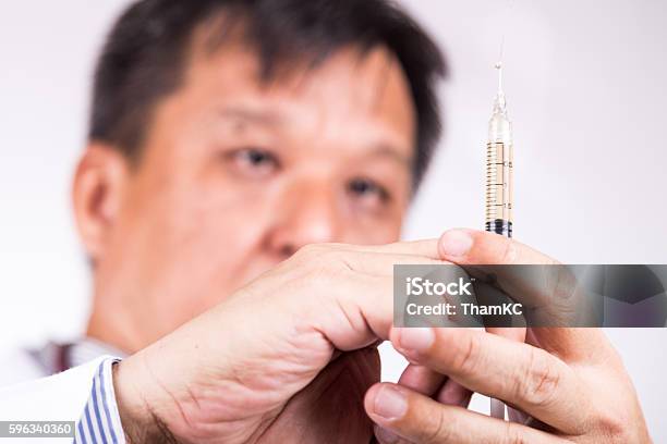 Closeup Of Medical Doctor Hand Holding Syringe For Injection Stock Photo - Download Image Now