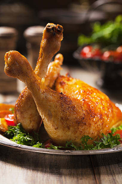 istock Baked chicken leg, served with roasted potatoes and vegetables. 596341002