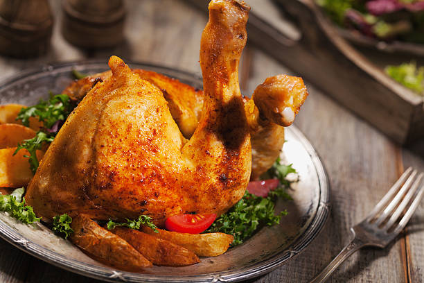 istock Baked chicken leg, served with roasted potatoes and vegetables. 596341074