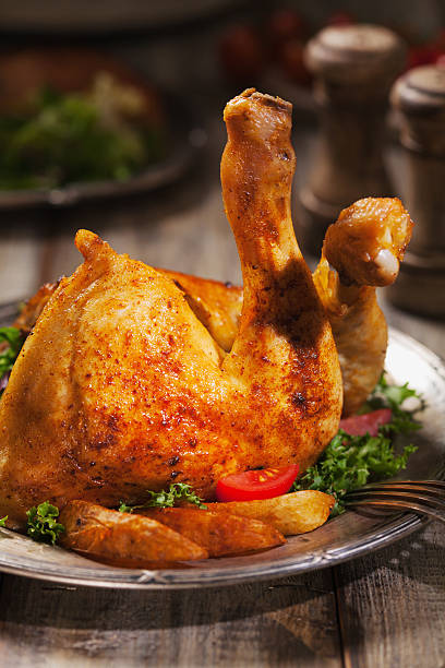 istock Baked chicken leg, served with roasted potatoes and vegetables. 596341150
