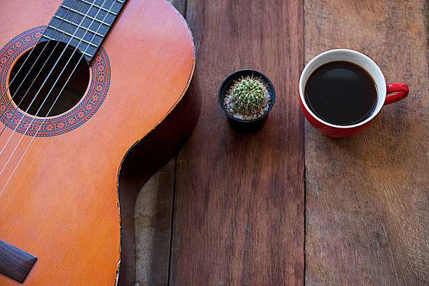 istock coffee cup and guitar on wooden table 596341430