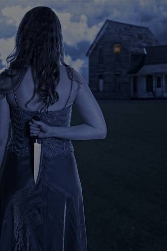 scary woman with knife outside house at night