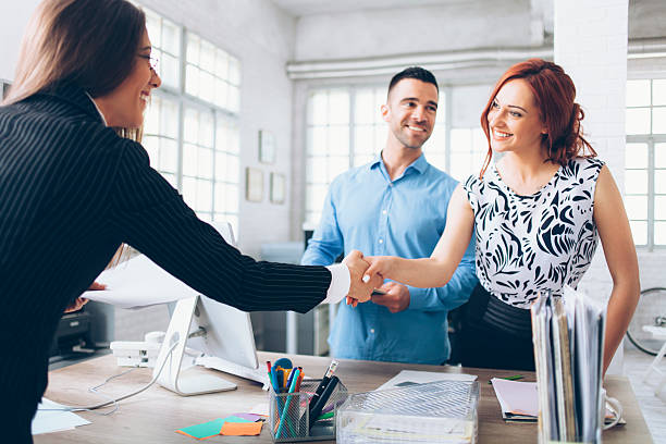 istock Young couple reaching an agreement with agent 596342170