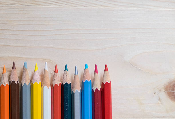 istock Colour pencils on wooden table 596342462