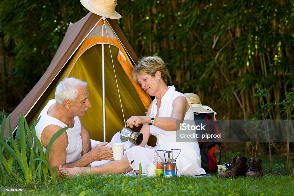 senior couple camping senior couple picnicking while camping 60-64 Years Stock Photo