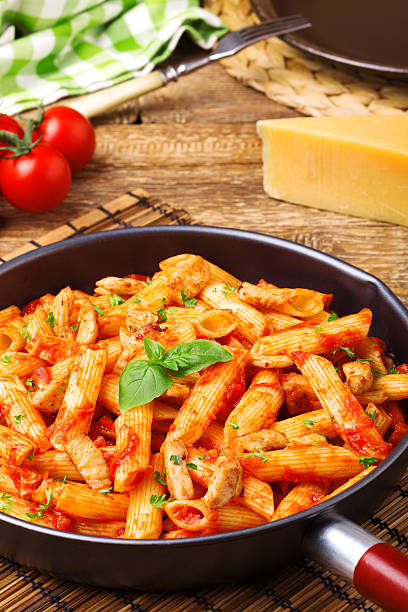 istock Penne with roasted chicken in tomato sauce 596342748