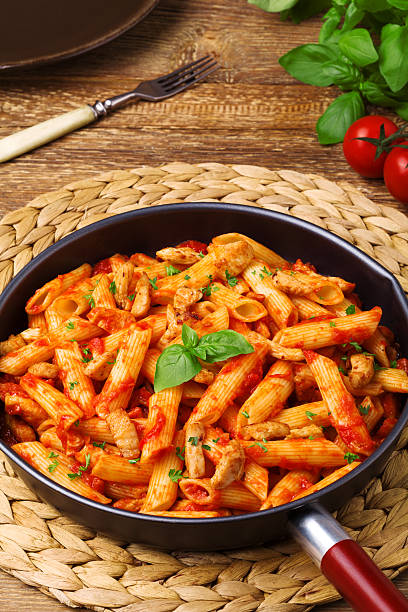 istock Penne with roasted chicken in tomato sauce 596342906