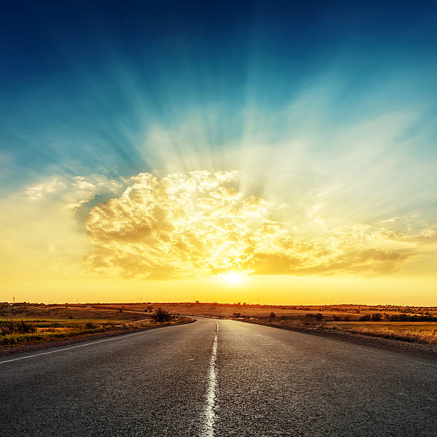 istock bright sunset and road to horizon 596343542