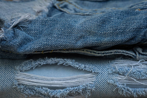 istock Closeup stack of old jean, Worn old jean 596343668