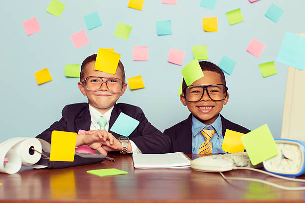 istock Two Young Businessmen at Desk Covered with Blank Sticky Notes 596344056