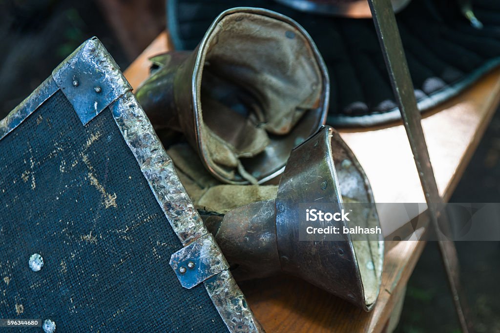 Details of the medieval knight armament Details of the medieval knight armament. Shield, metal sword, iron gloves. Preparation for a historic reenactment performance. Equipment Stock Photo