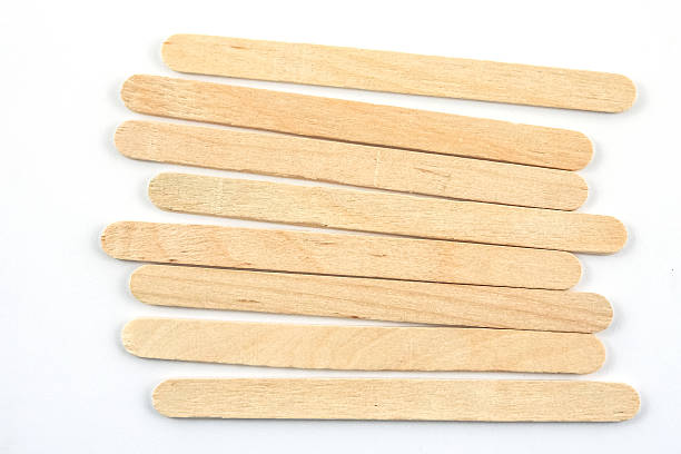 istock wood ice cream sticks on white background 596344684