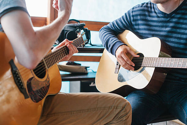 learning to play the guitar. music education and extra-curricular lessons. - music lesson imagens e fotografias de stock