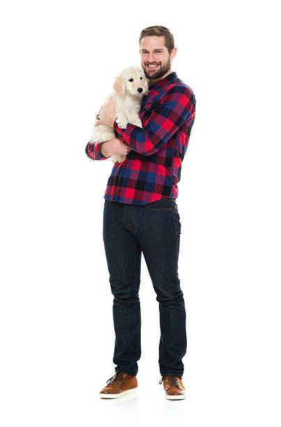istock Smiling man embracing with his puppy 596345148
