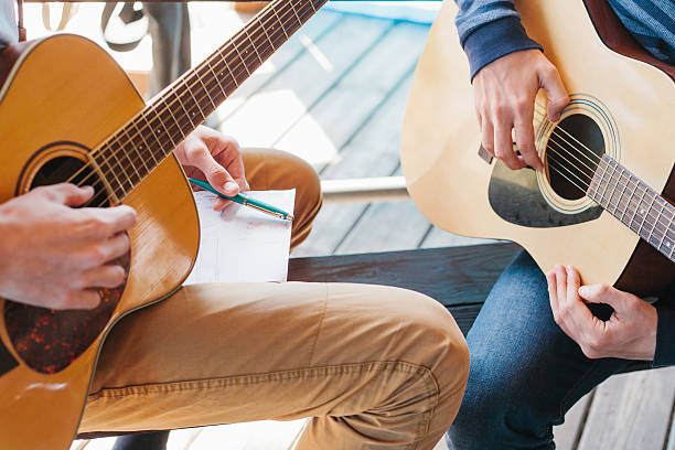 istock Learning to play the guitar. Music education and extra-curricular lessons. 596345528