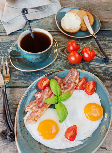 istock Fried eggs,  bacon, tomato, toast and a cup of coffee 596346628