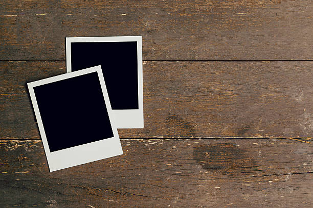 istock Vintage photo frame blank on old wood background with space 596348114
