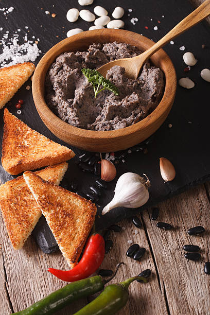 istock paste of black beans with ingredients close-up. vertical 596348144