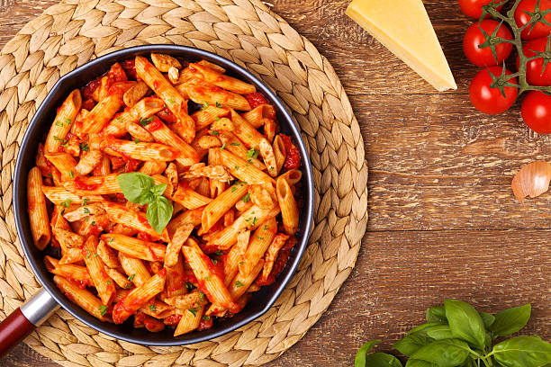 istock Penne with roasted chicken in tomato sauce 596348412