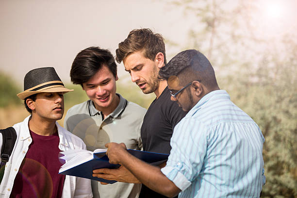 istock Senior college student explaining freshmen about new syllabus. 596349122