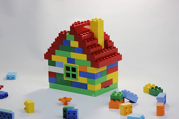 istock Colorful toy house with bricks in mess 596349188