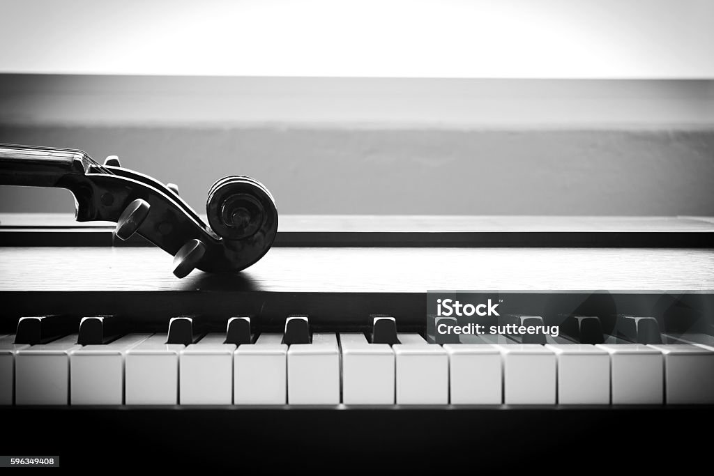 Violin on piano. Black and White color tone. Violin on piano. Black and White color tone. Art and music concept. Still life and hight contrast style. With dark vignette. Piano Stock Photo