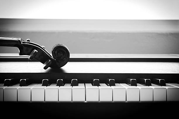 Violin on piano. Black and White color tone. Violin on piano. Black and White color tone. Art and music concept. Still life and hight contrast style. With dark vignette. musical instrument bridge stock pictures, royalty-free photos & images