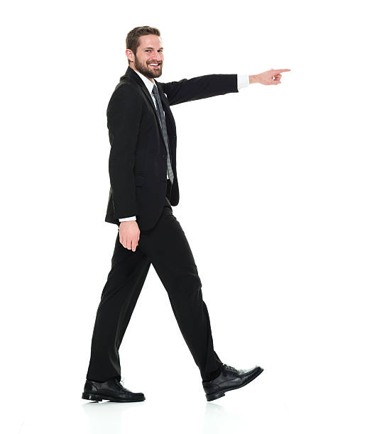 istock Smiling businessman pointing away 596349492