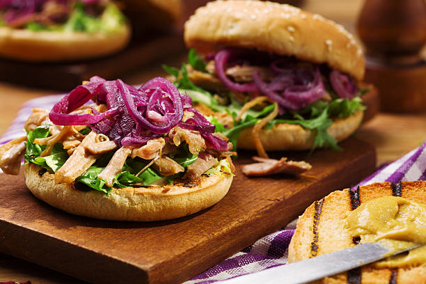 Burger with meat of duck with red onion and lettuce.