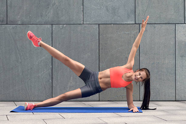 istock Fit young woman doing planks 596352352