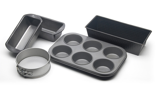 Different types of baking pans and moulds for cake, bread and muffins.