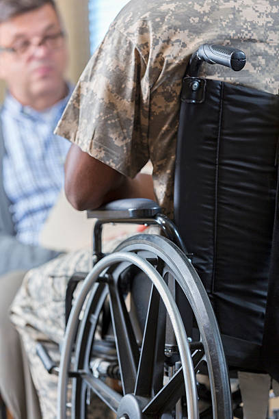 istock Counselor talking to young soldier during therapy session 596359422