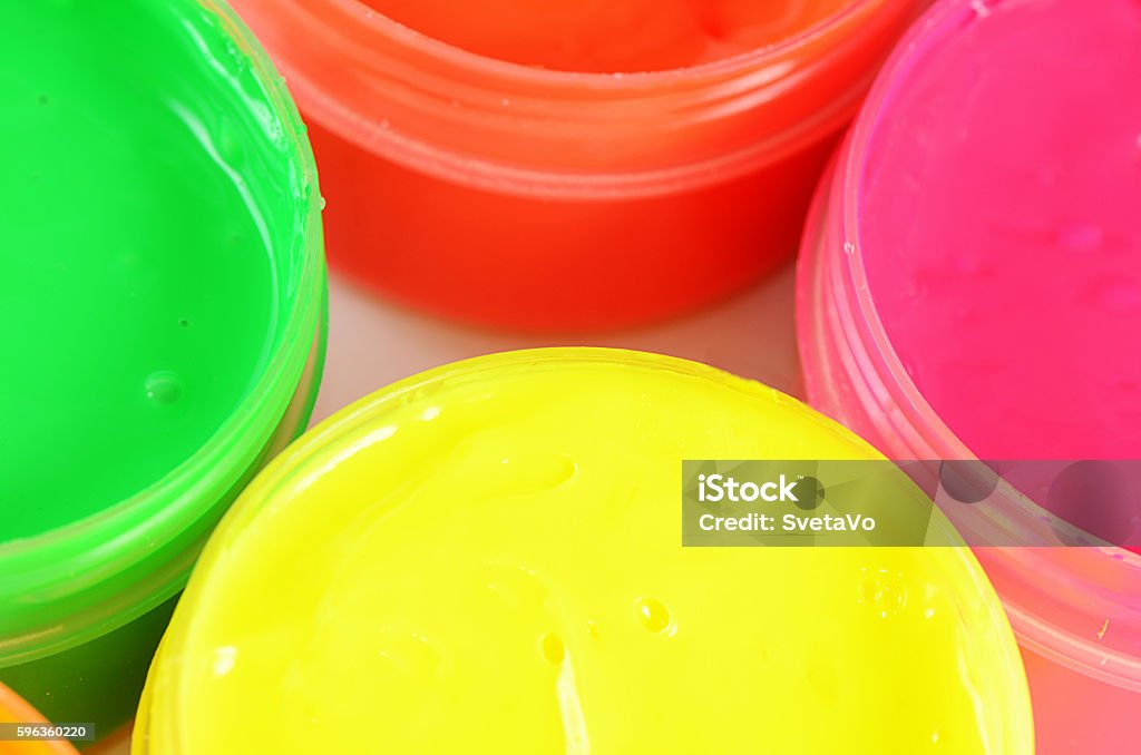 Children's colorful finger paints in jars Children's colorful finger paints in plastic jars Art Stock Photo