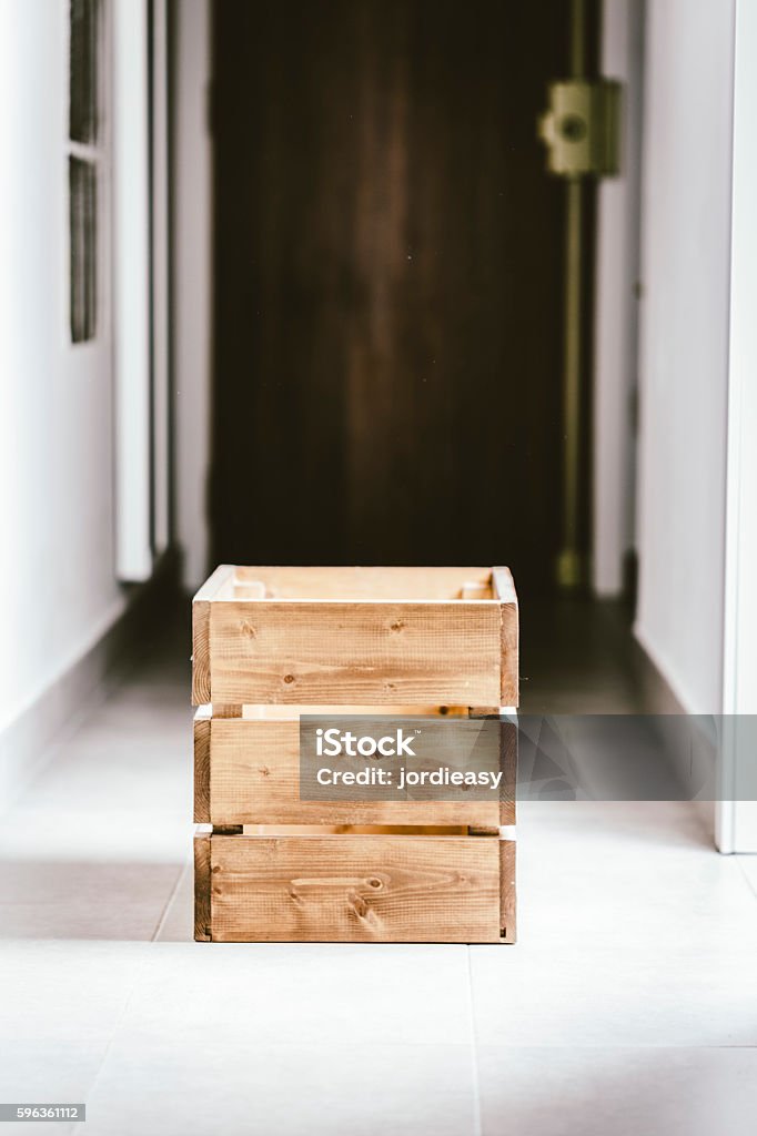 Wooden container box on a dark corridor Empty wooden container box in the middle of an indoor dark home corridor Box - Container Stock Photo