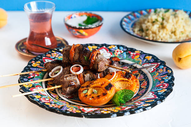 istock Lamb kebab with dried apricot, bulgur and rose tea 596361546