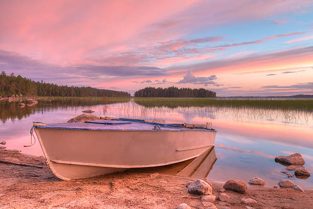 istock Boat on shore of lake in beautiful evening 596362882