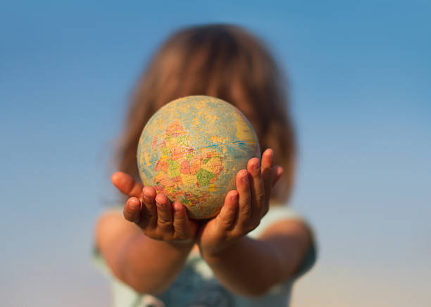 Earth holding in human on two hand at wait on black background. World environment day and green earth. Energy saving environment nature conservation concept. Elements of this image furnished by NASA.