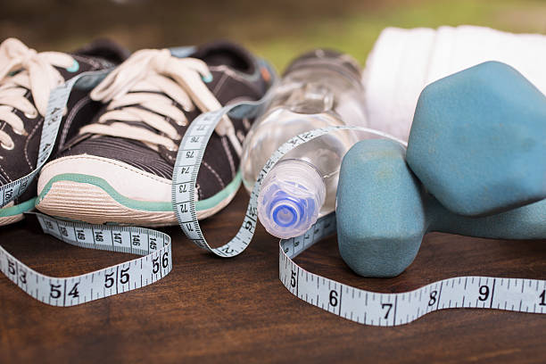 istock Fitness, exercise themed scene with weights, sneakers, water. 596364366