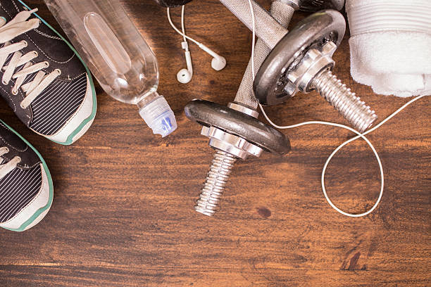 istock Fitness, exercise themed scene with weights, sneakers, earbuds. 596365268